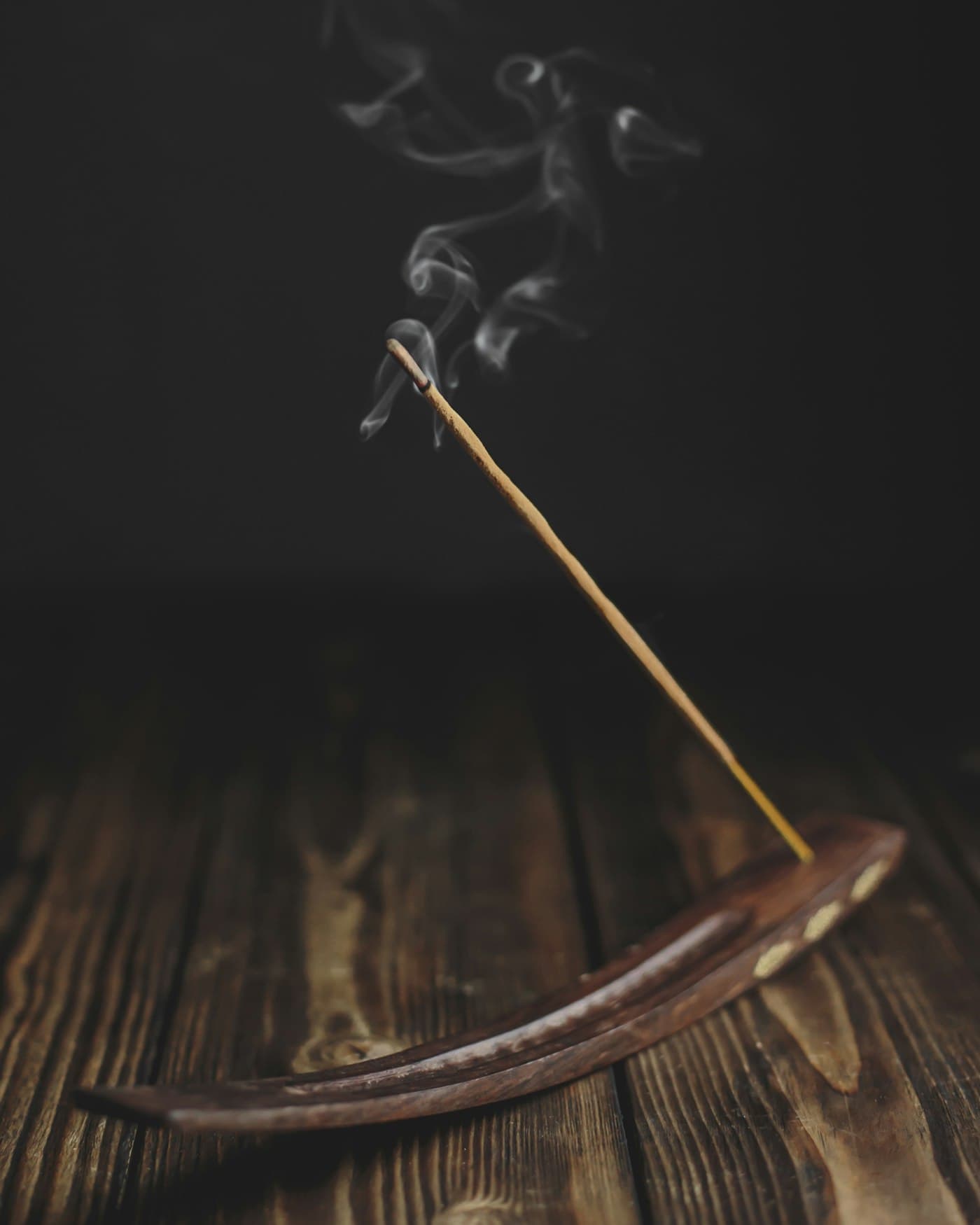 A stick of incense with rising smoke